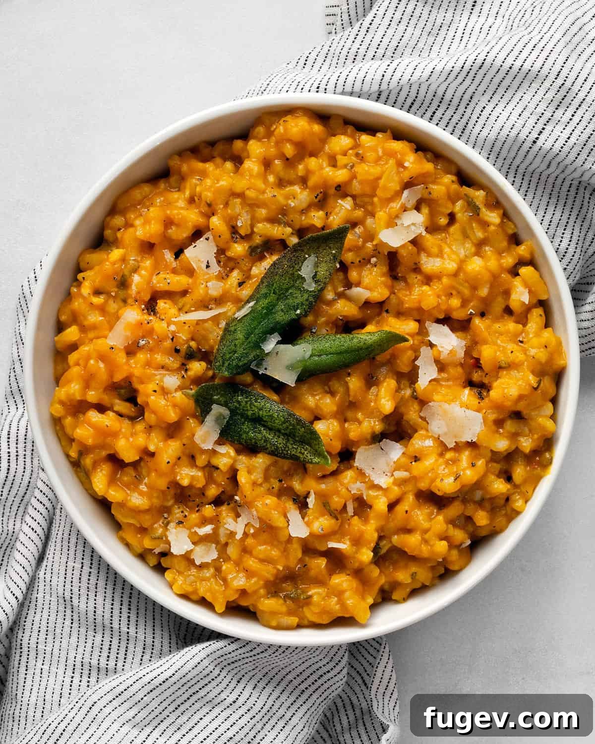 Velvet Pumpkin Risotto 2 A bowl of creamy baked pumpkin risotto topped with crispy sage leaves, ready to be enjoyed.