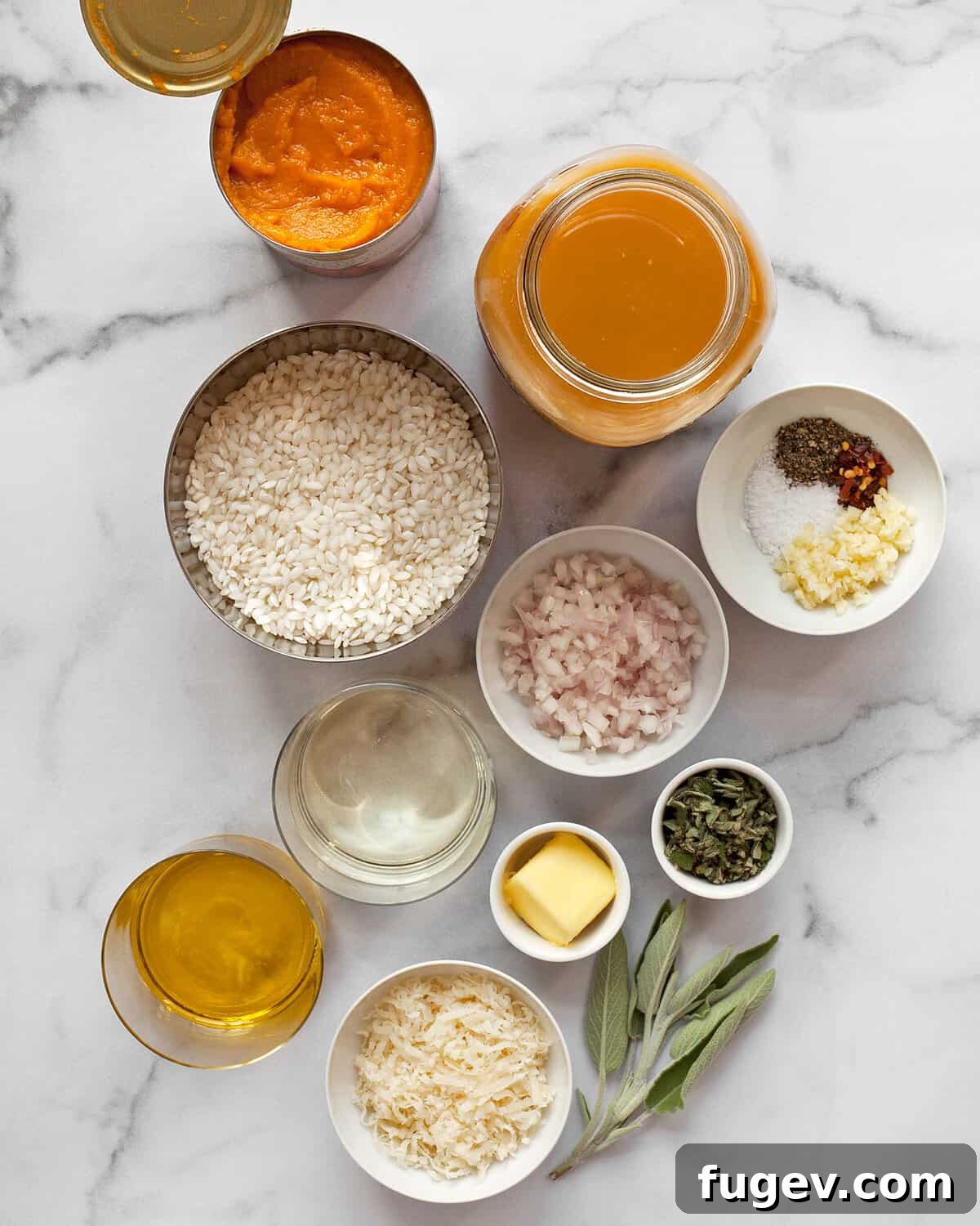 Velvet Pumpkin Risotto 4 A flat lay photograph showcasing all the ingredients for pumpkin risotto: Arborio rice, pumpkin puree, Parmesan cheese, minced garlic, chopped shallots, olive oil, vegetable broth, fresh sage, and a blend of spices.
