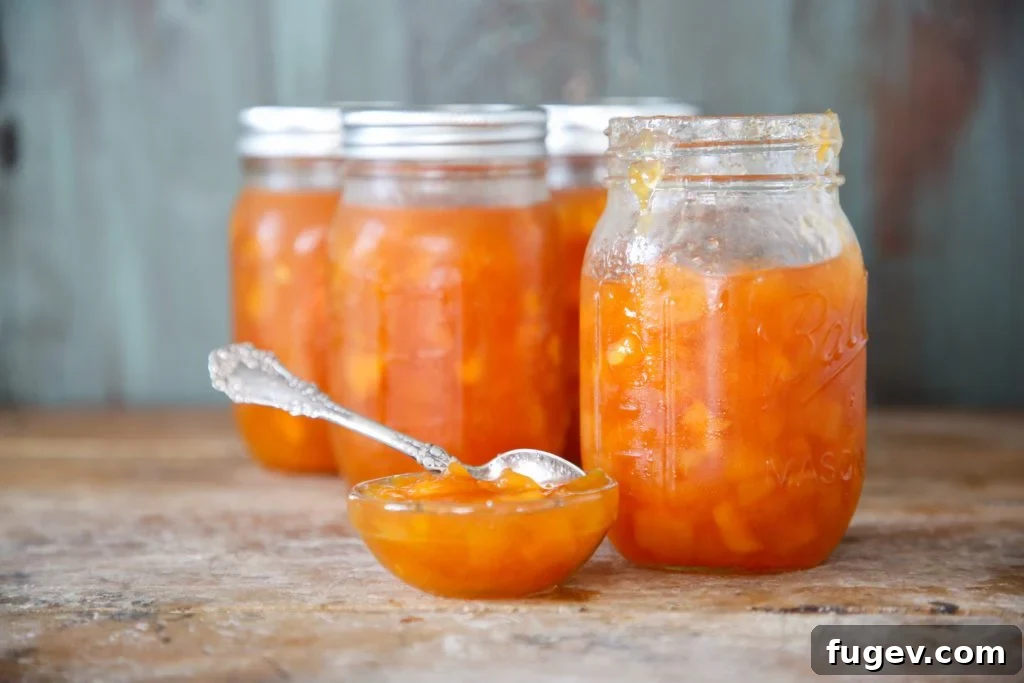 Effortless Pectin-Free Peach Preserves Recipe 5 A spoonful of peach preserves being added to yogurt, illustrating a serving suggestion.