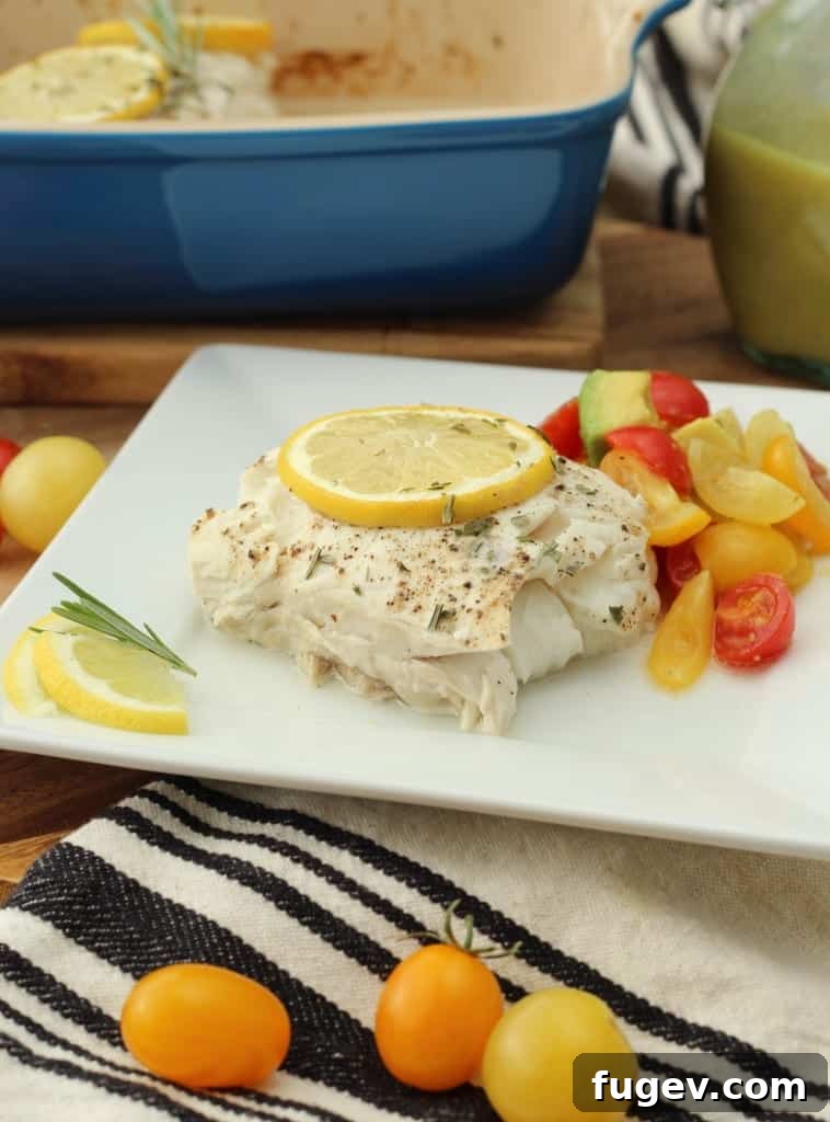 Baked Halibut with Effervescent Champagne Vinaigrette 10 Side view of a baked halibut fillet, garnished with fresh herbs, showcasing its perfect doneness and juicy interior.