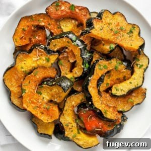 Parmesan roasted acorn squash on a plate.