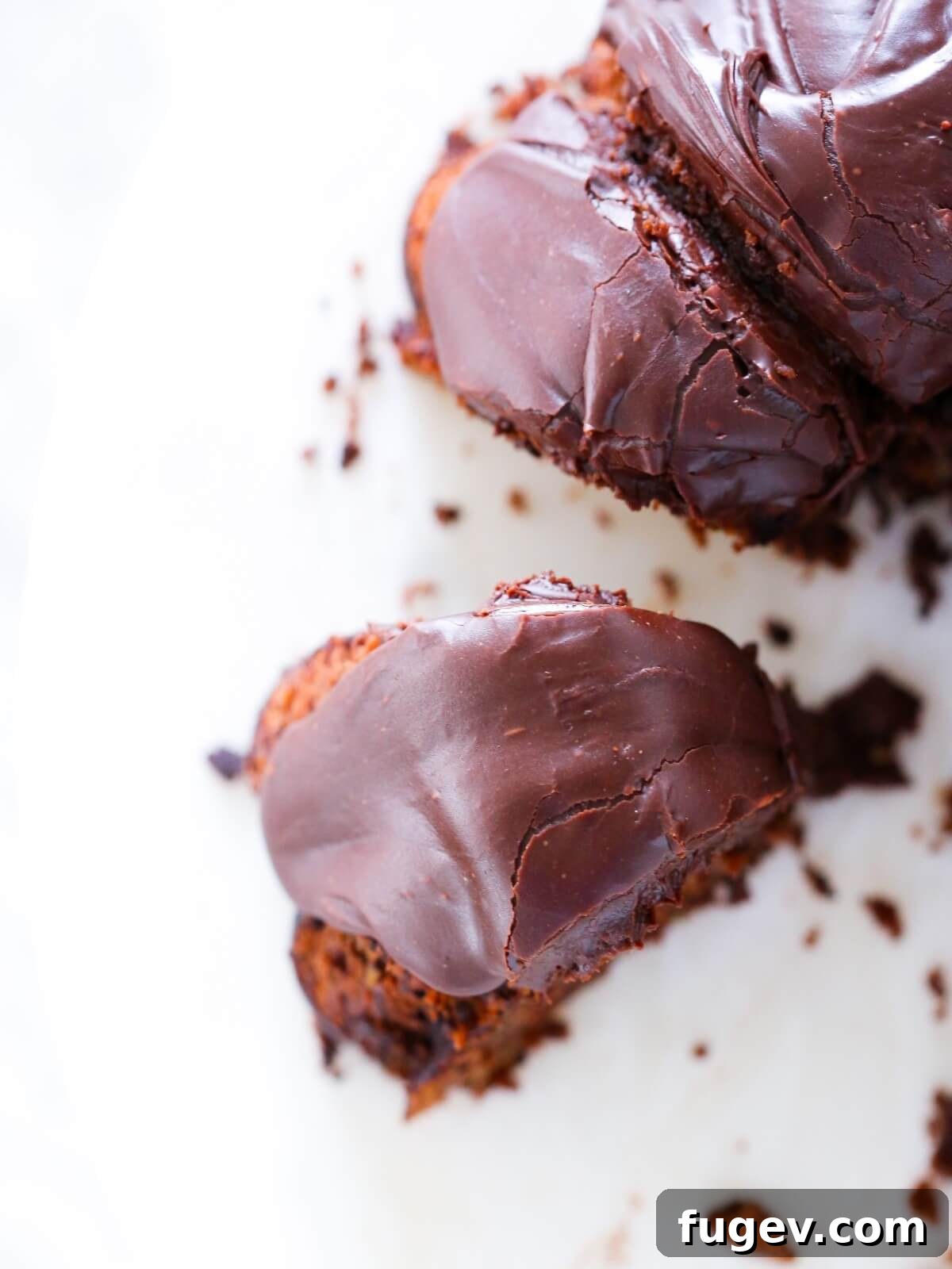 Secret Zucchini Chocolate Indulgence 2 A perfectly sliced chocolate zucchini cake on a pristine white plate, showcasing its rich, dark interior and moist texture.