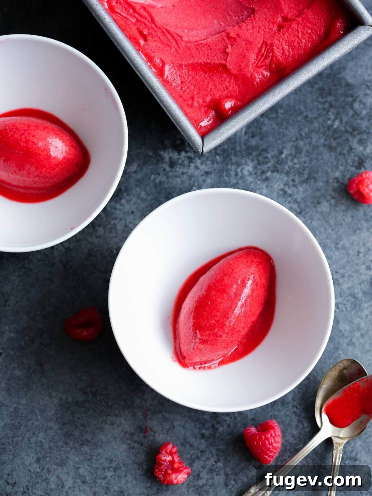 Crimson Berry Bliss 2 Raspberry sorbet served in two elegant white bowls, garnished with fresh raspberries.