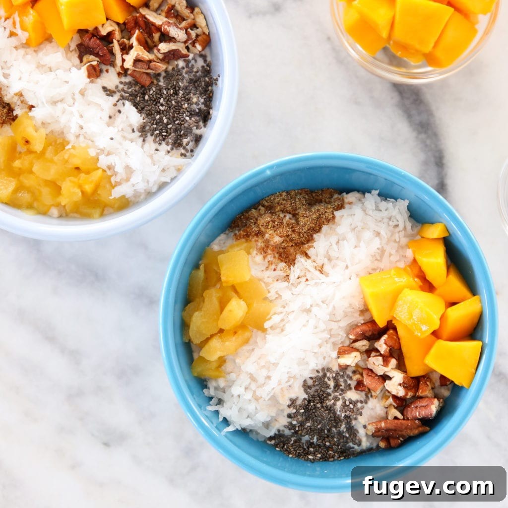 Island Oasis Overnight Oats 6 A bowl of creamy tropical overnight oats with fresh fruit and a spoon, ready to be enjoyed.