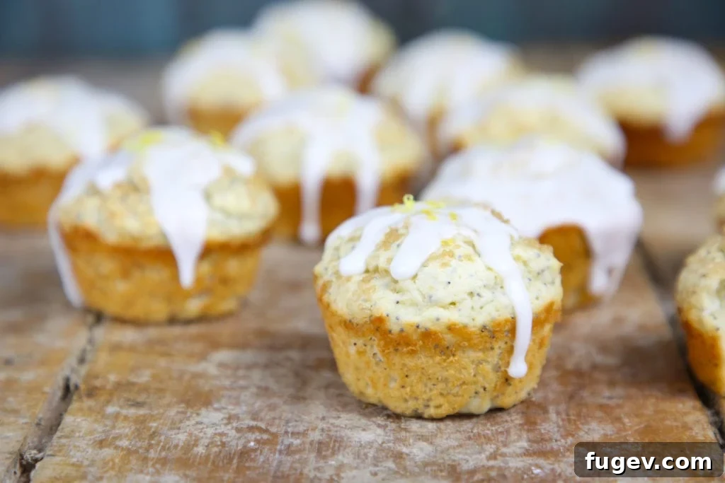 Zesty Lemon Poppyseed Muffins 3 Close-up of a Lemon Poppy Seed Muffin with a generous drizzle of lemon glaze and visible poppy seeds
