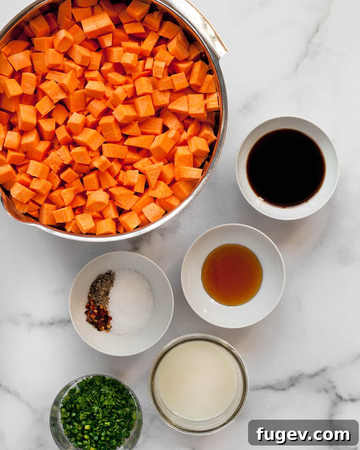 Nourishing Sweet Potato Mash 3 A vibrant flat lay of fresh ingredients: sweet potatoes, a bottle of balsamic vinegar, golden honey, a glass of milk, red pepper flakes, salt, pepper, and a bundle of fresh herbs.
