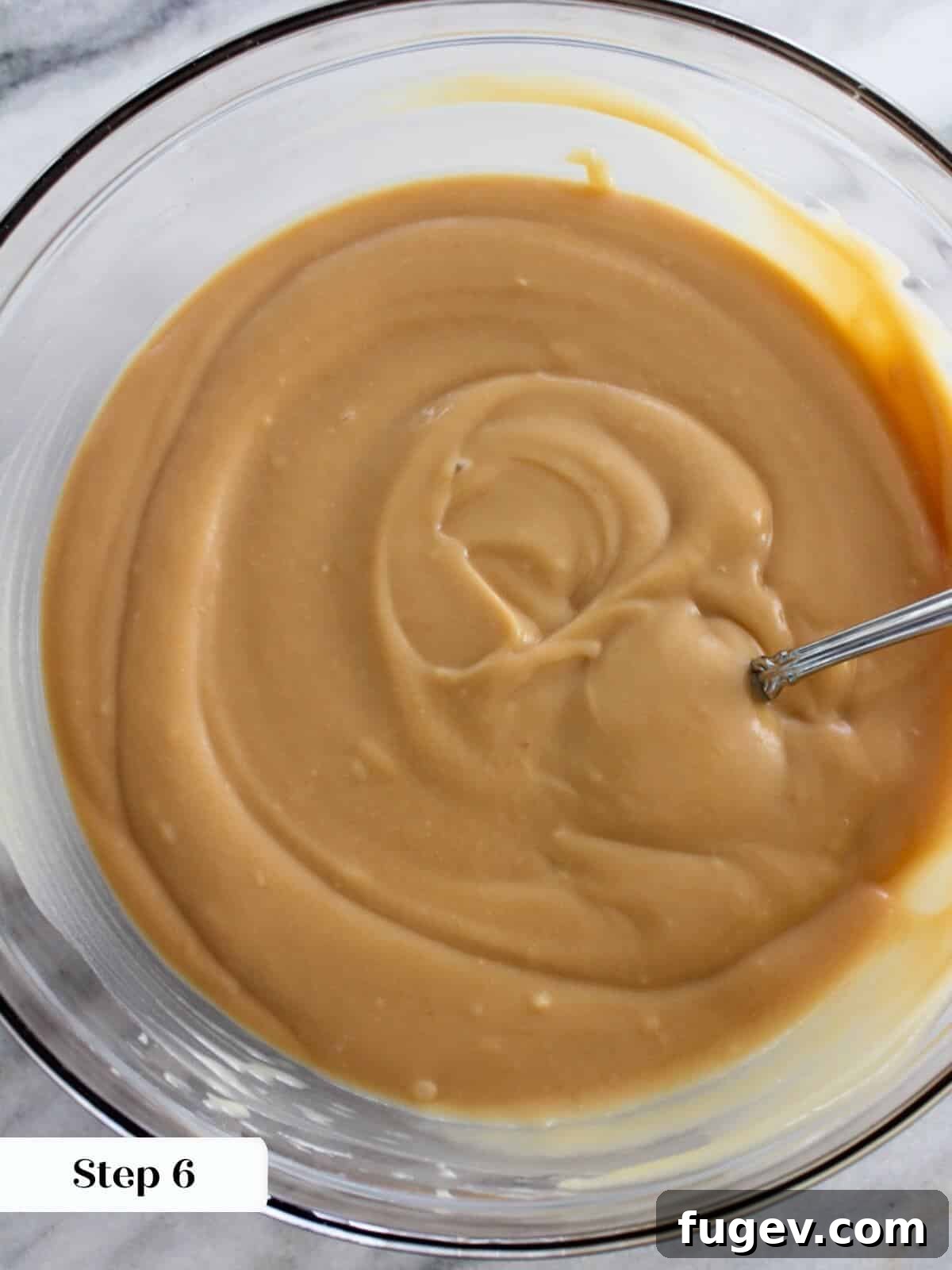Decadent Caramel Pudding 7 Chilled caramel pudding in a glass dish, perfectly set and ready for serving, showcasing its smooth surface.