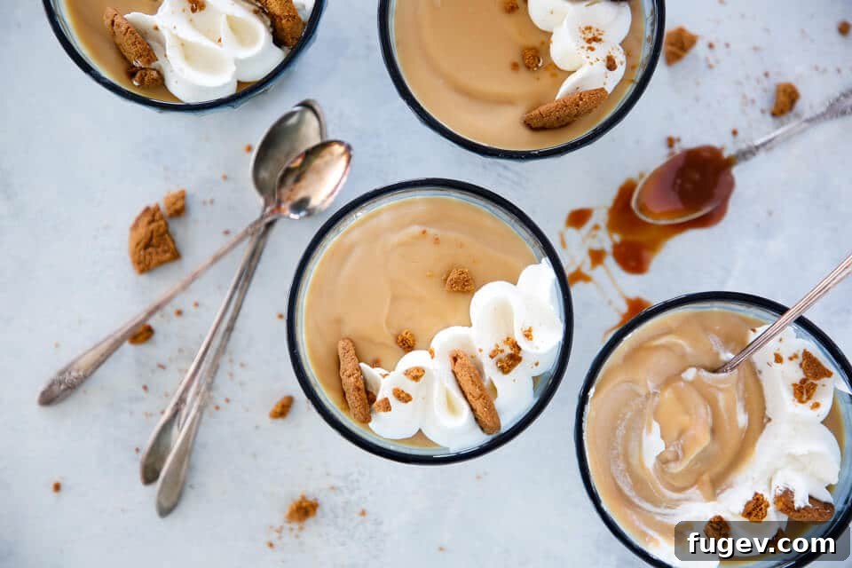 Decadent Caramel Pudding 9 Four elegant glass coupes filled with smooth, golden caramel pudding, beautifully presented for a dessert spread.