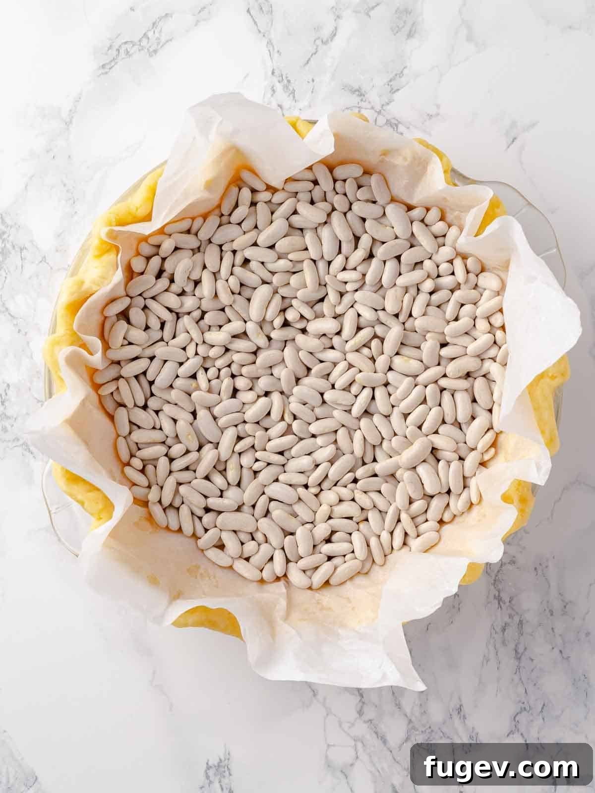 Sweet Tart Dough 5 Pâte Sucrée blind baking with ceramic baking beans, keeping the crust in shape.