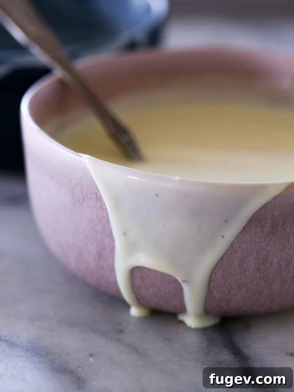 Elegant Vanilla Custard Drizzle 5 creme anglaise dripping down side of pink bowl.