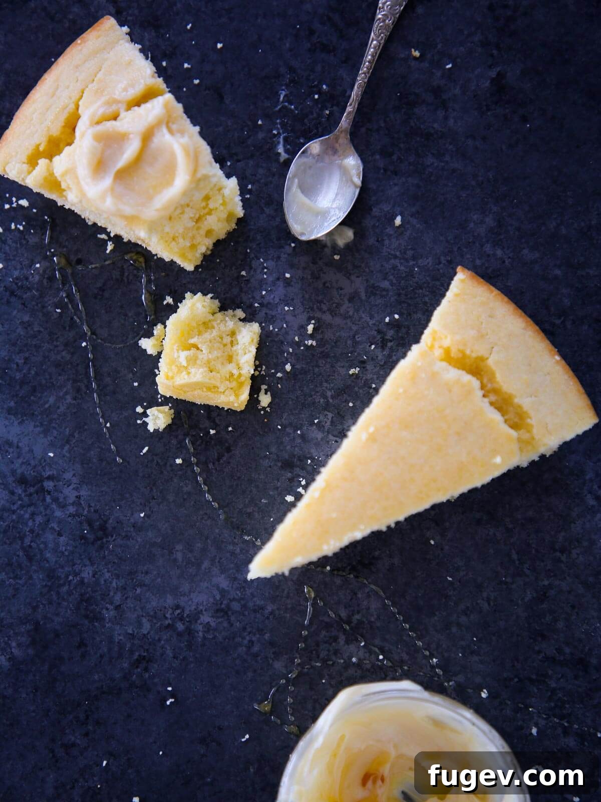 Southern Cornbread Perfection 13 A charming blue surface featuring two perfectly baked slices of Southern cornbread, generously drizzled with butter and honey.
