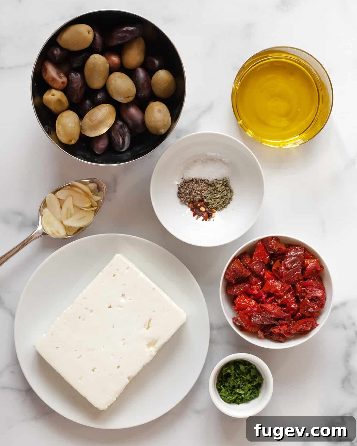 Roasted Feta with Burst Tomatoes and Olives 3 Ingredients including feta, tomatoes, olives, olive oil, garlic and spices.