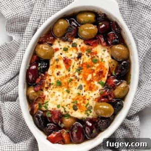 Roasted Feta with Burst Tomatoes and Olives 7 Feta in a baking dish with tomatoes and olives.
