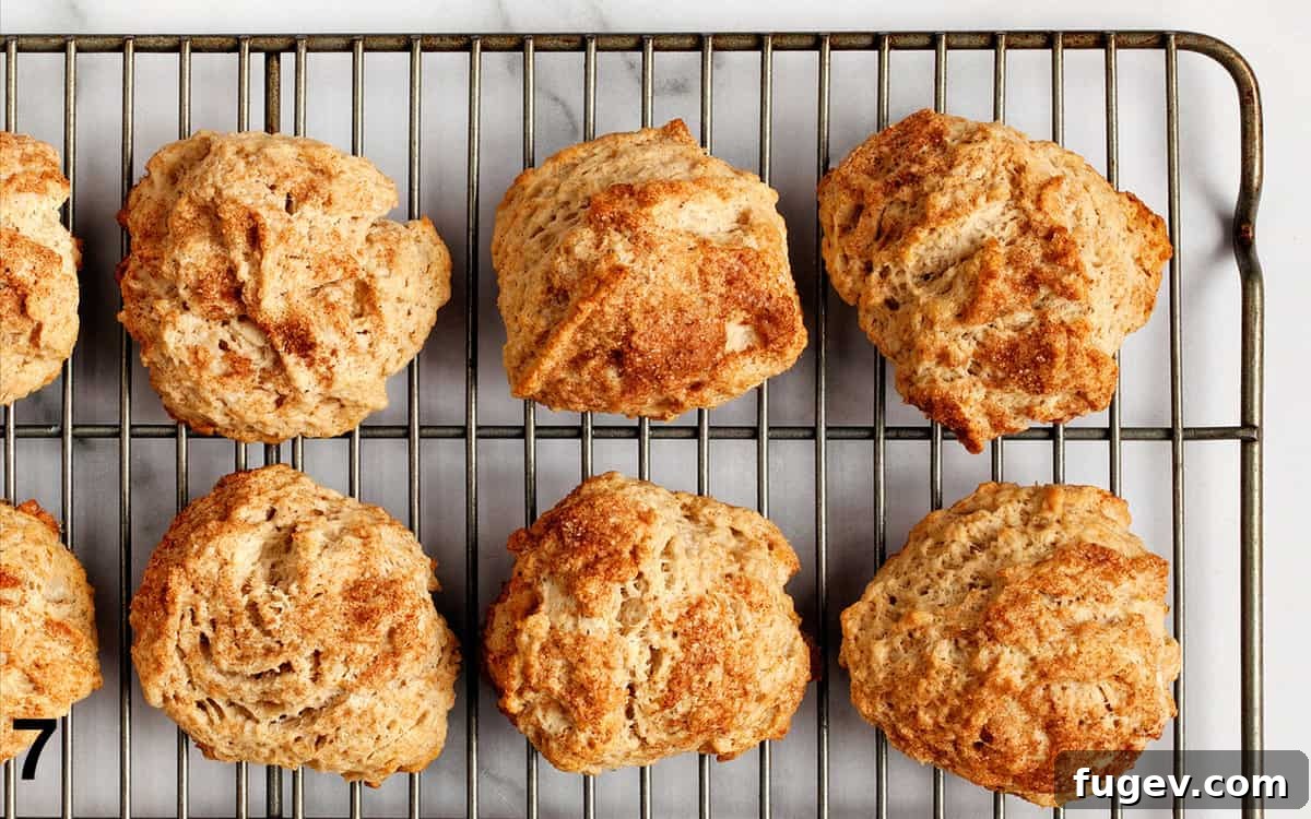 Cozy Cinnamon Scones 7 Freshly baked cinnamon scones cooling on a wire rack.