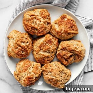 Seven baked cinnamon scones on a plate, ready to be served.