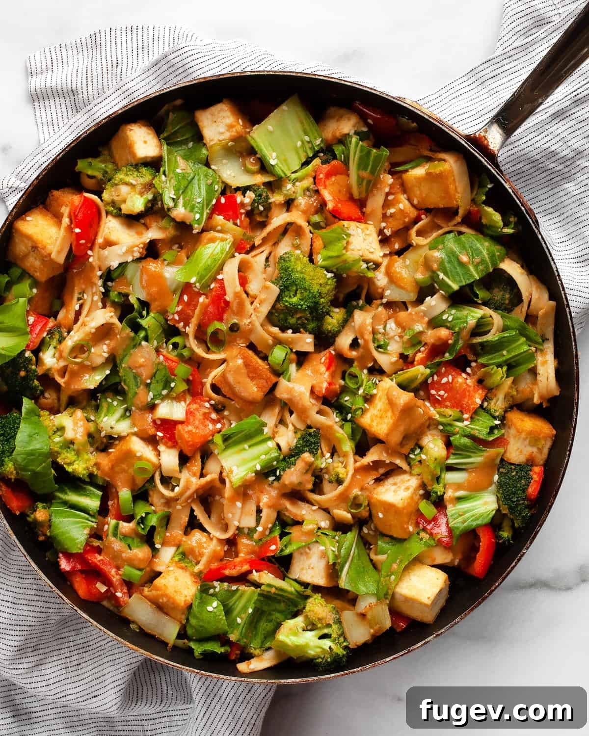Creamy Peanut Tofu Veggie Stir-Fry 7 A large skillet filled with freshly cooked tofu vegetable stir-fry.