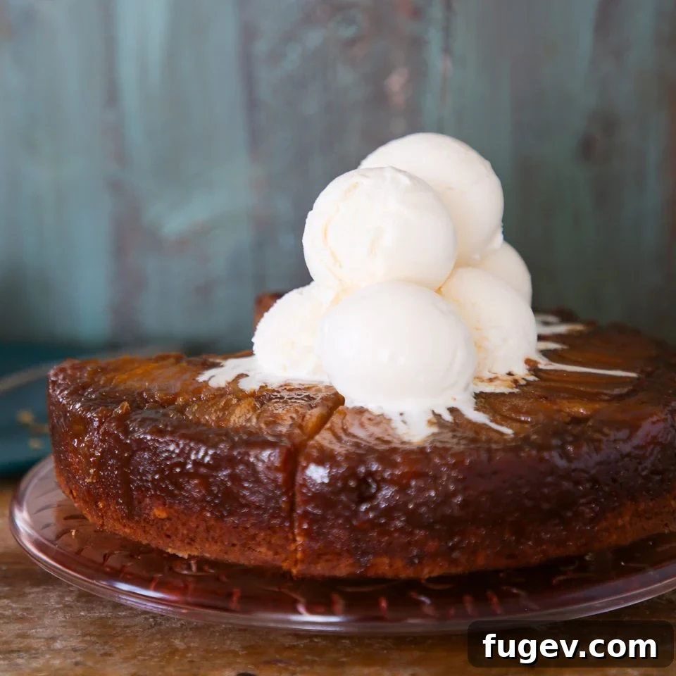 Caramelized Pear Delight 3 Pear upside down cake with scoops of vanilla ice cream on top, ready to be served.