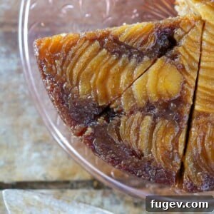 Pear Upside Down Cake sliced on a pink cake plate