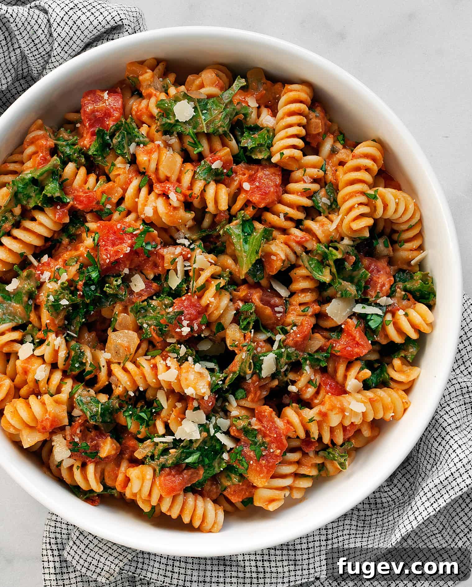 Velvety Mushroom and Tomato Pasta 8 Creamy Tomato Mushroom Pasta with kale, garnished with Parmesan and parsley