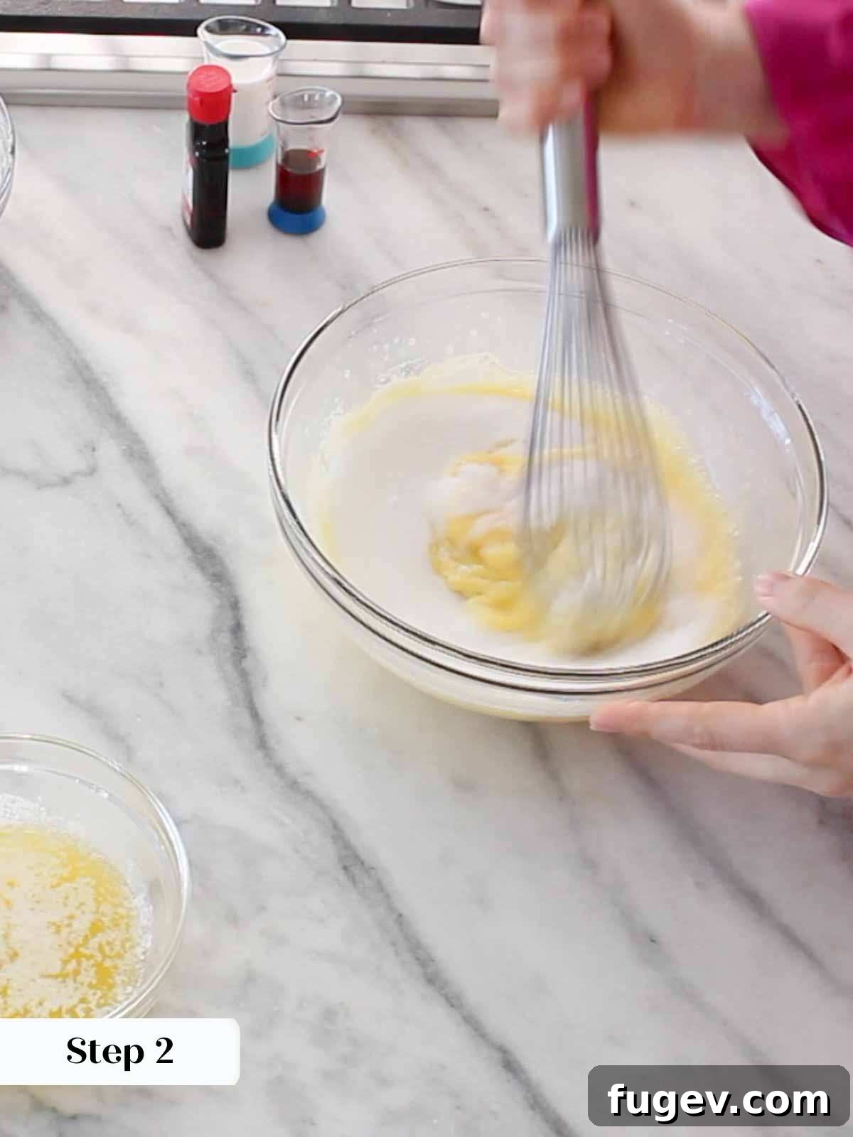Sweet Italian Iron-Pressed Delights 6 Whisking the wet ingredients for pizzelle batter in a bowl.