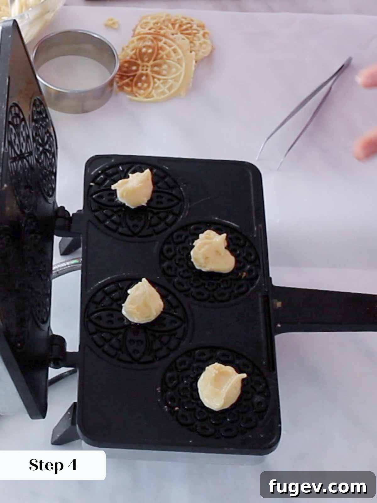 Sweet Italian Iron-Pressed Delights 8 Dropping a spoonful of pizzelle batter onto a preheated pizzelle press.
