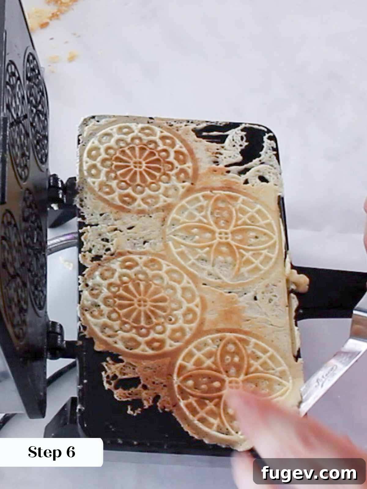 Sweet Italian Iron-Pressed Delights 9 Golden brown pizzelles being carefully removed from the hot iron.