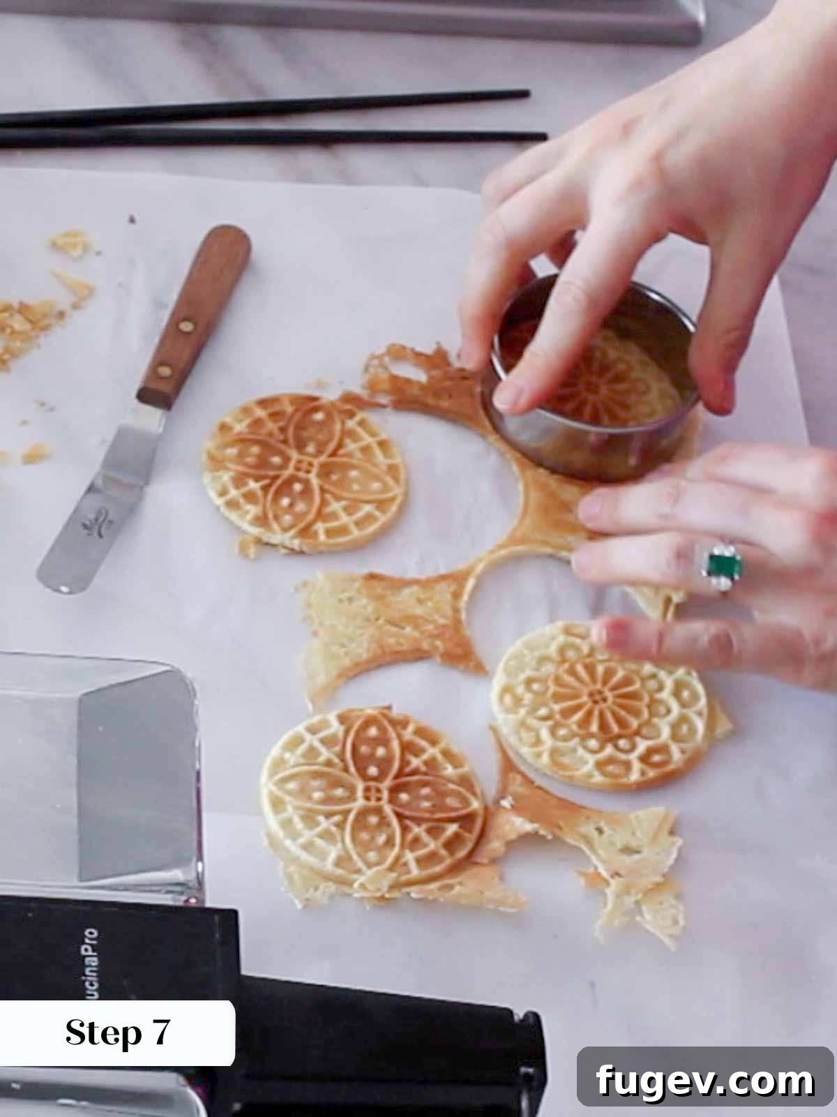 Sweet Italian Iron-Pressed Delights 10 Cutting freshly cooked pizzelle cookies into perfect circles with a round cookie cutter.