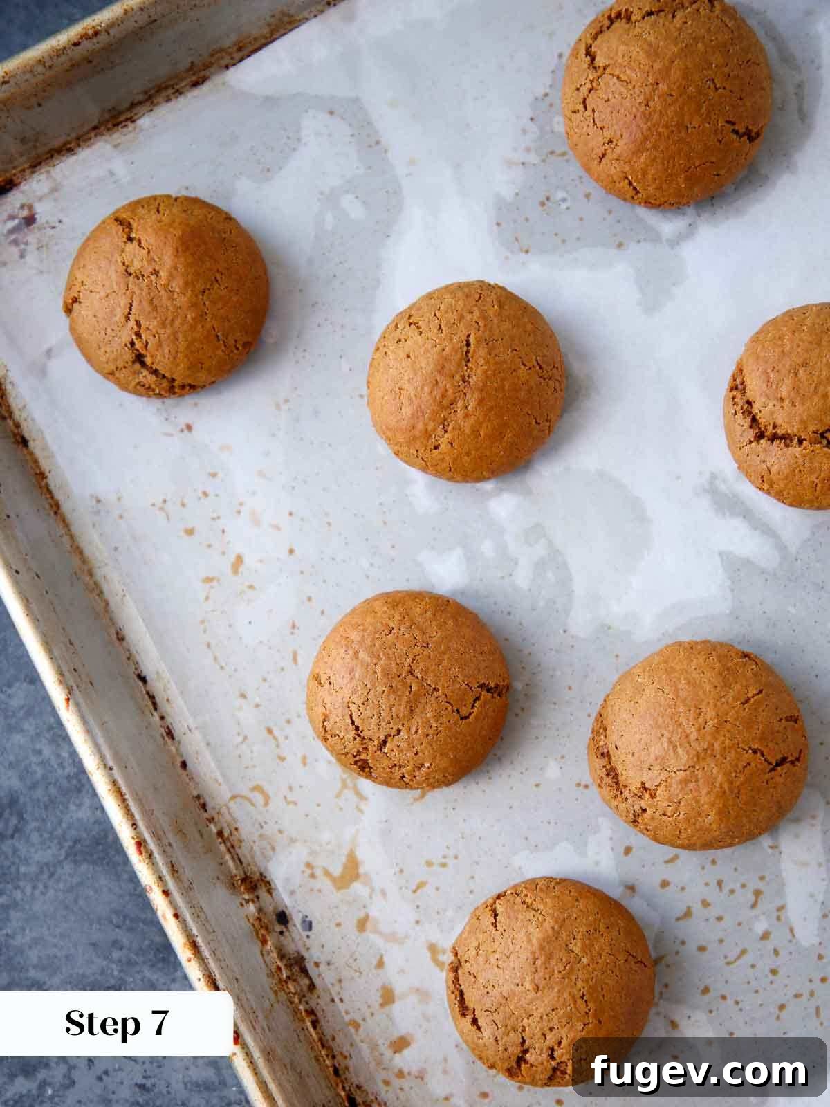 Holiday Spice Drops 9 baked pfeffernusse cookies on baking sheet cooling.
