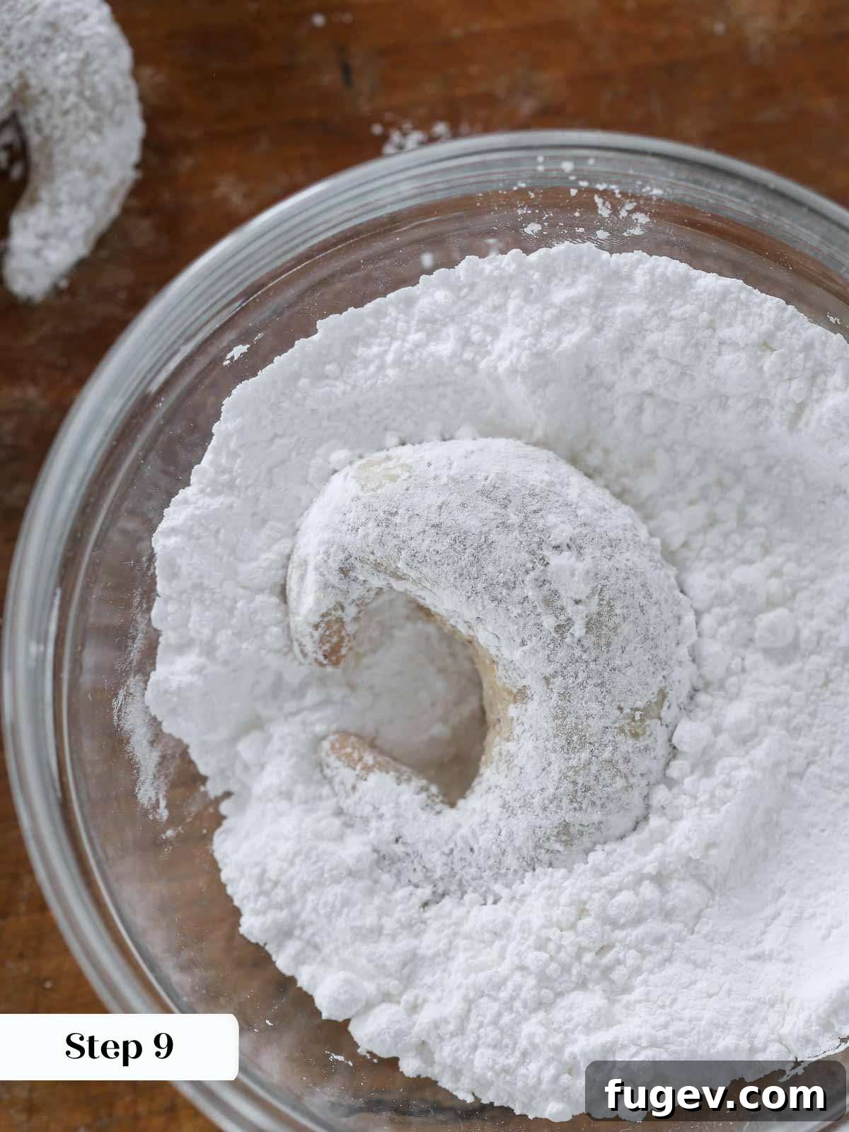 Velvet Almond Crescents 11 crescent cookie in powdered sugar bowl.