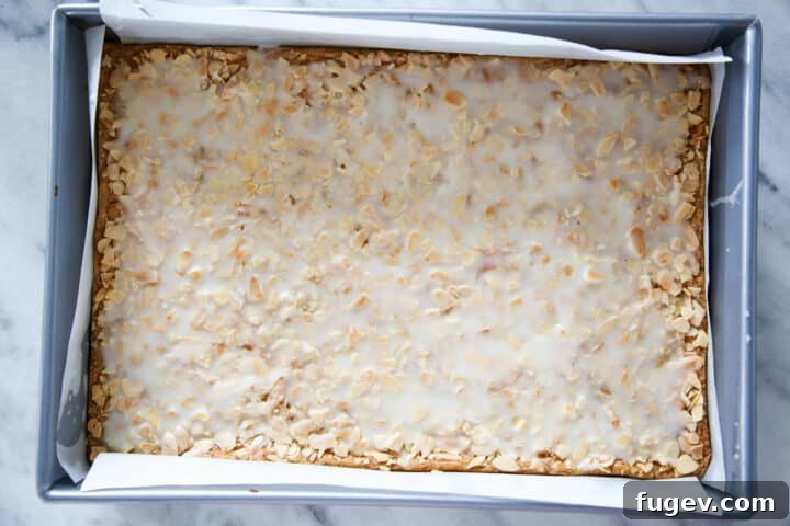 Golden Almond Squares 3 Crunchy almond cookies uncut in a silver pan.
