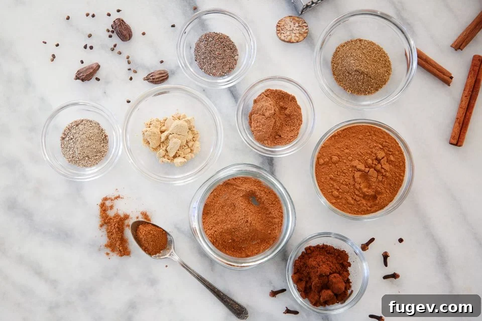 Homemade Speculoos Spice Blend 4 Various whole and ground spices, including cinnamon sticks, star anise, and cloves, artfully arranged around a bowl of prepared Speculoos Spice Mix.