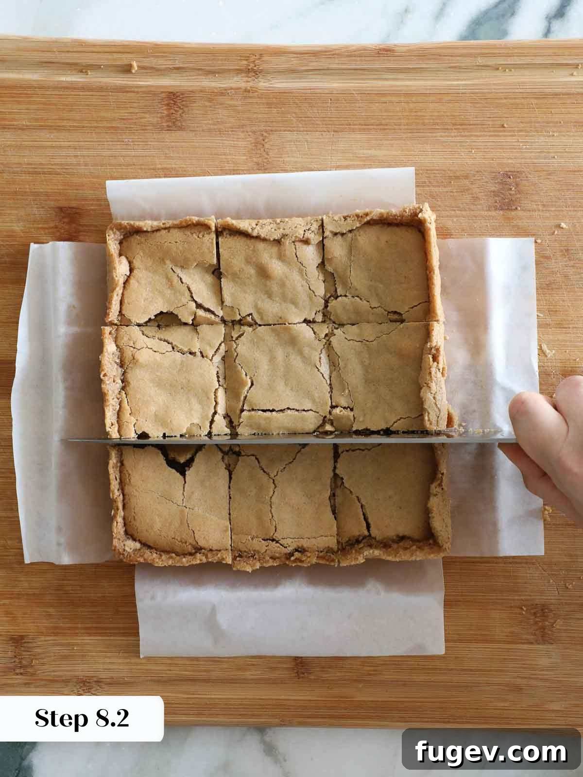 Butterscotch Blondies 13 Cutting perfectly cooled butterscotch brownies on a cutting board, ready to be served.