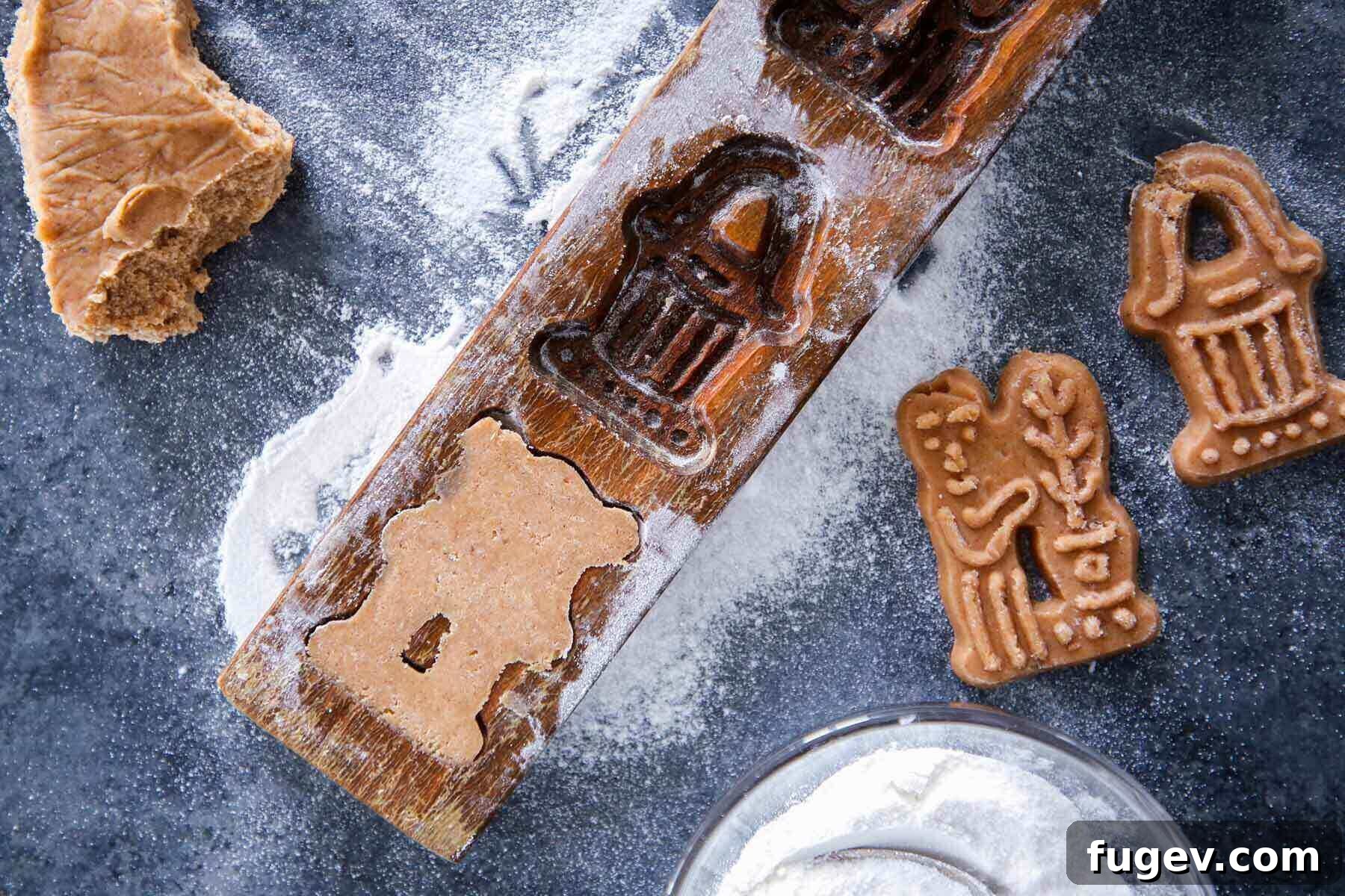 Timeless Speculoos Spice Cookies 4 Traditional wooden mold in use for pressing cookie dough.