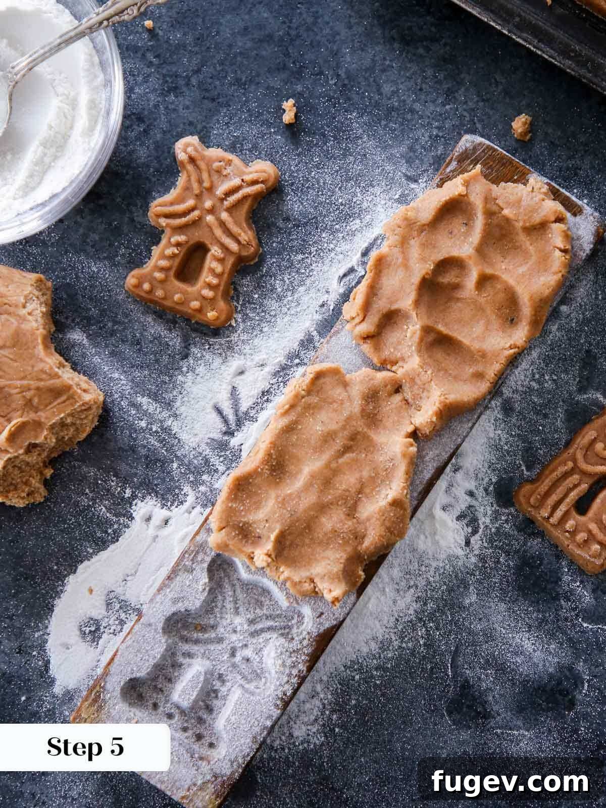 Timeless Speculoos Spice Cookies 5 Dough being pressed into a vintage wooden cookie mold.