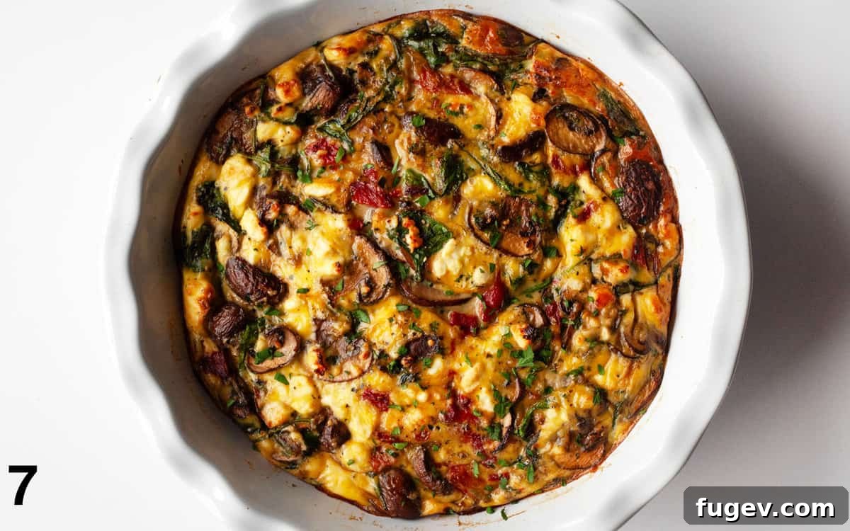 Savory Mushroom, Pepper, and Spinach Frittata 7 A golden-brown baked crustless quiche in a pie dish, fresh out of the oven.