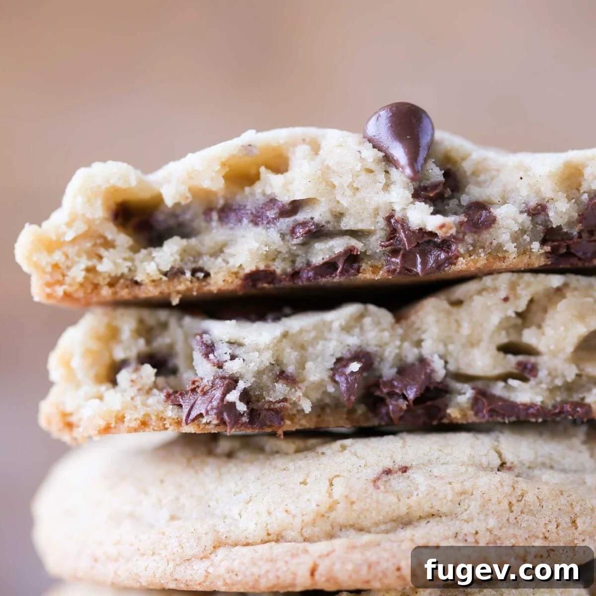 20 Festive Christmas Cookie Recipes 16 chocolate chip cookie broken open with melty chips.