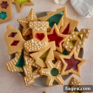 20 Festive Christmas Cookie Recipes 19 cookies with colored centers in various shapes and sizes.
