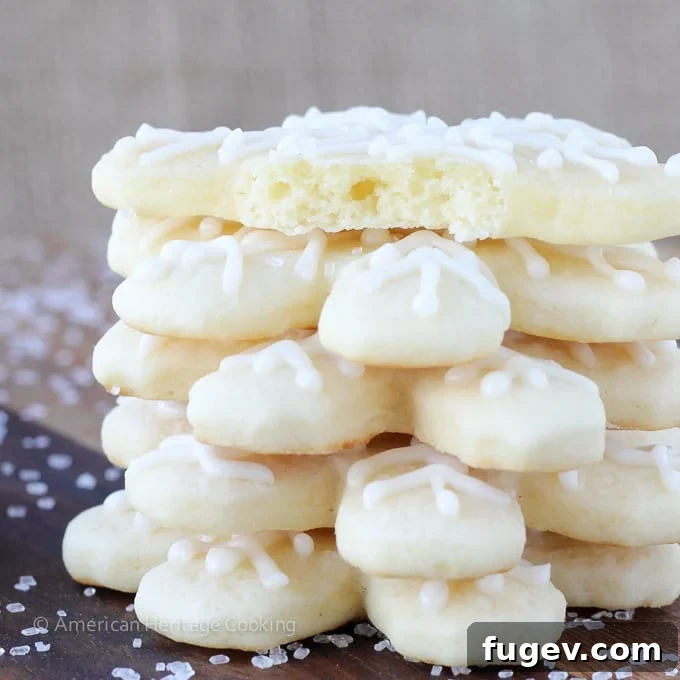 20 Festive Christmas Cookie Recipes 22 soft sugar cookies shaped like snowflakes stacked.