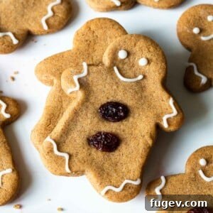 20 Festive Christmas Cookie Recipes 25 gingerbread boy with raisin decorations.