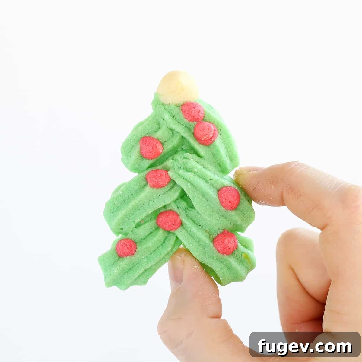 20 Festive Christmas Cookie Recipes 42 Holiday Spritz cookie Christmas tree in hand.