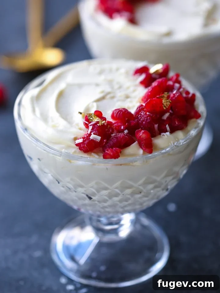 Velvet Raspberry White Chocolate Dream 3 Close-up of a White Chocolate Raspberry Mousse in a glass, showing its creamy texture and vibrant raspberry layer.