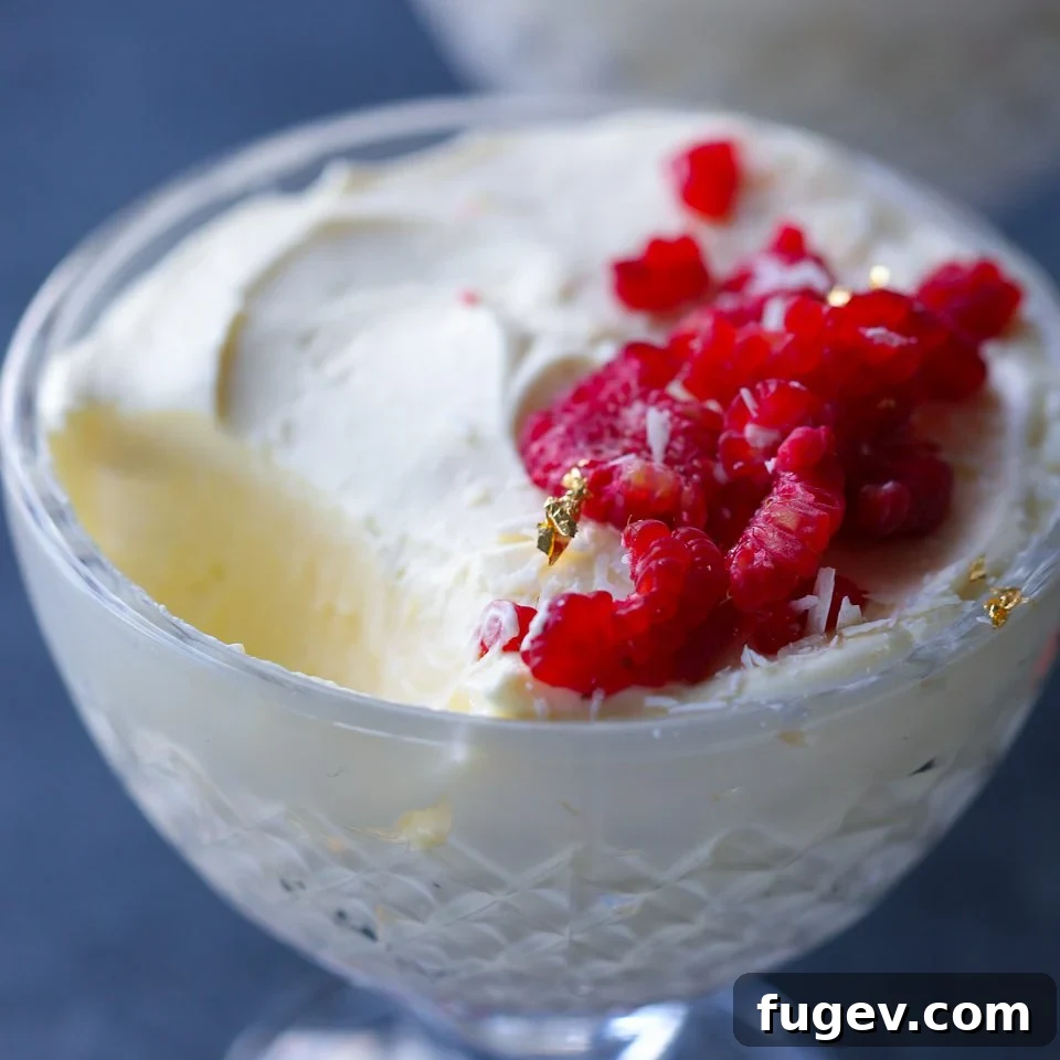 Velvet Raspberry White Chocolate Dream 5 Close-up of a White Chocolate Raspberry Mousse, highlighting its smooth texture and elegant presentation.