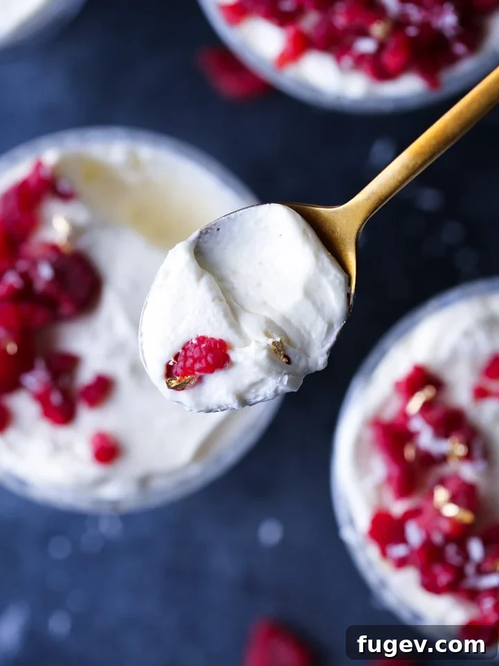Velvet Raspberry White Chocolate Dream 6 A beautifully set White Chocolate Raspberry Mousse in a serving dish, garnished with fresh berries.