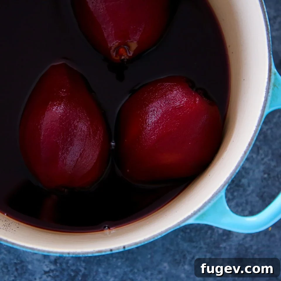 Crimson Poached Pears 5 Red Wine Poached Pears in a pot with poaching liquid