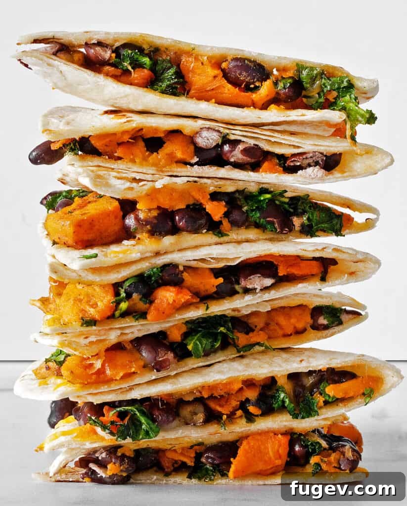 Savory Roasted Sweet Potato Black Bean Quesadillas 7 A stack of perfectly cut sweet potato black bean quesadilla wedges, showcasing the colorful filling and golden tortillas.