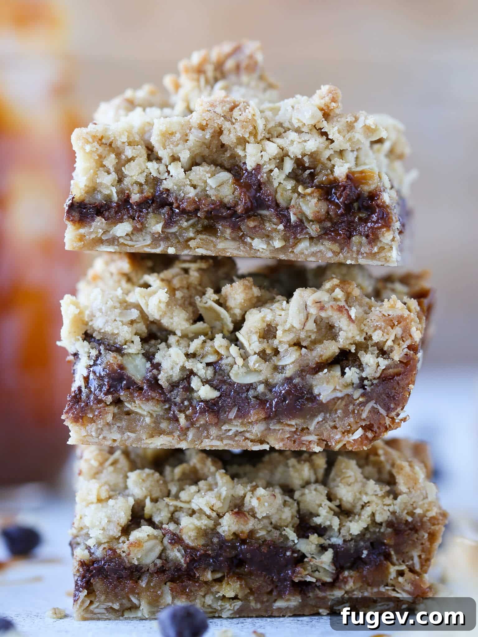 Chewy Caramel Oat Bars 2 Stacked Caramelita Cookie Bars showing layers of oat crust, caramel, and chocolate