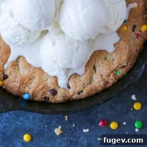 Deep Dish Cookie 6 Unsliced pizookie baked in a cast iron skillet, ready to be served.