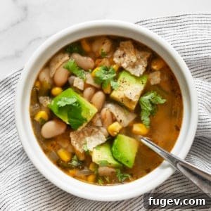 Creamy Vegan Poblano White Bean Chili 8 A vibrant bowl of vegan poblano white bean chili, garnished with fresh toppings.
