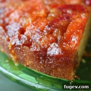 Golden brown edges of orange upside down cake on a green plate.