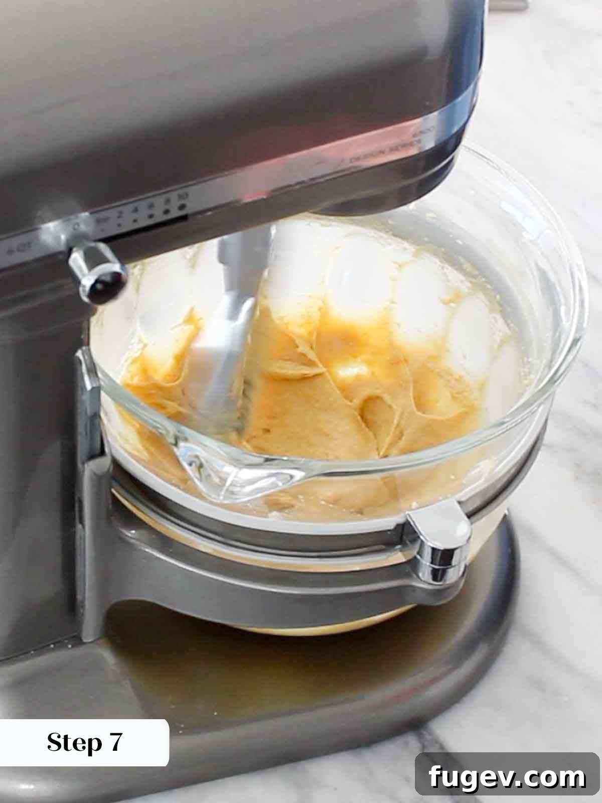 Golden Orange Inversion 10 Mixing cake batter in a stand mixer, ready for baking.